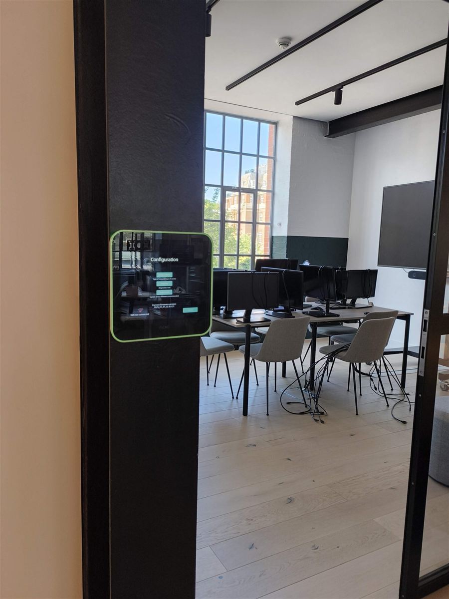 Room booking panel outside a meeting room in the Partnerize Central London office