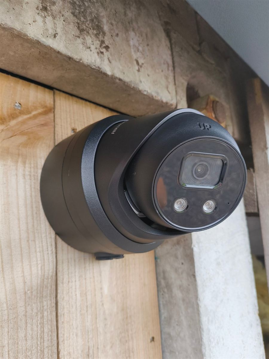Black turret CCTV camera installed on a timber beam in Morpeth