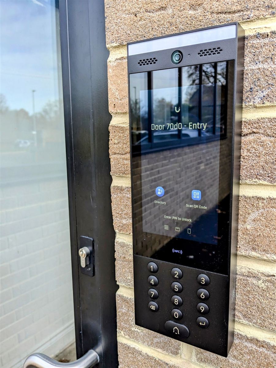 UniFi Access intercom with touchscreen, NFC and PIN keypad beside an office entrance door