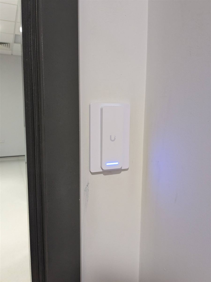UniFi Access door reader beside an office doorway