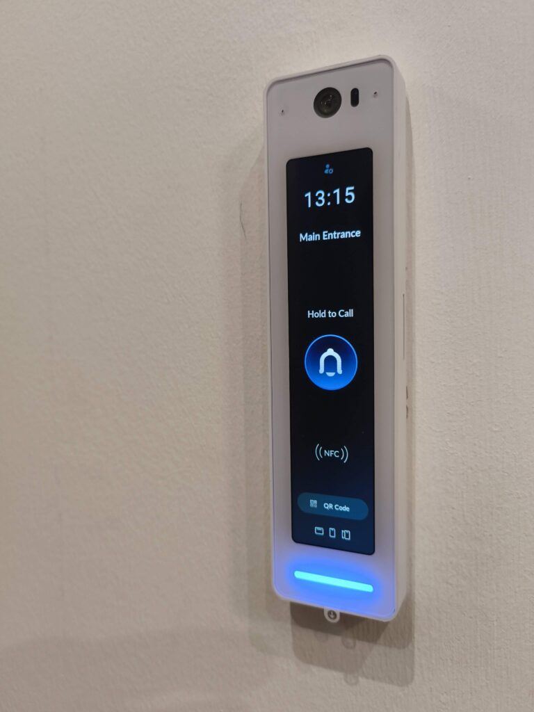UniFi Access video reader with call button, NFC and QR code entry at a main entrance