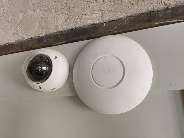 UniFi Wi-Fi access point installed next to a dome CCTV camera in Newcastle